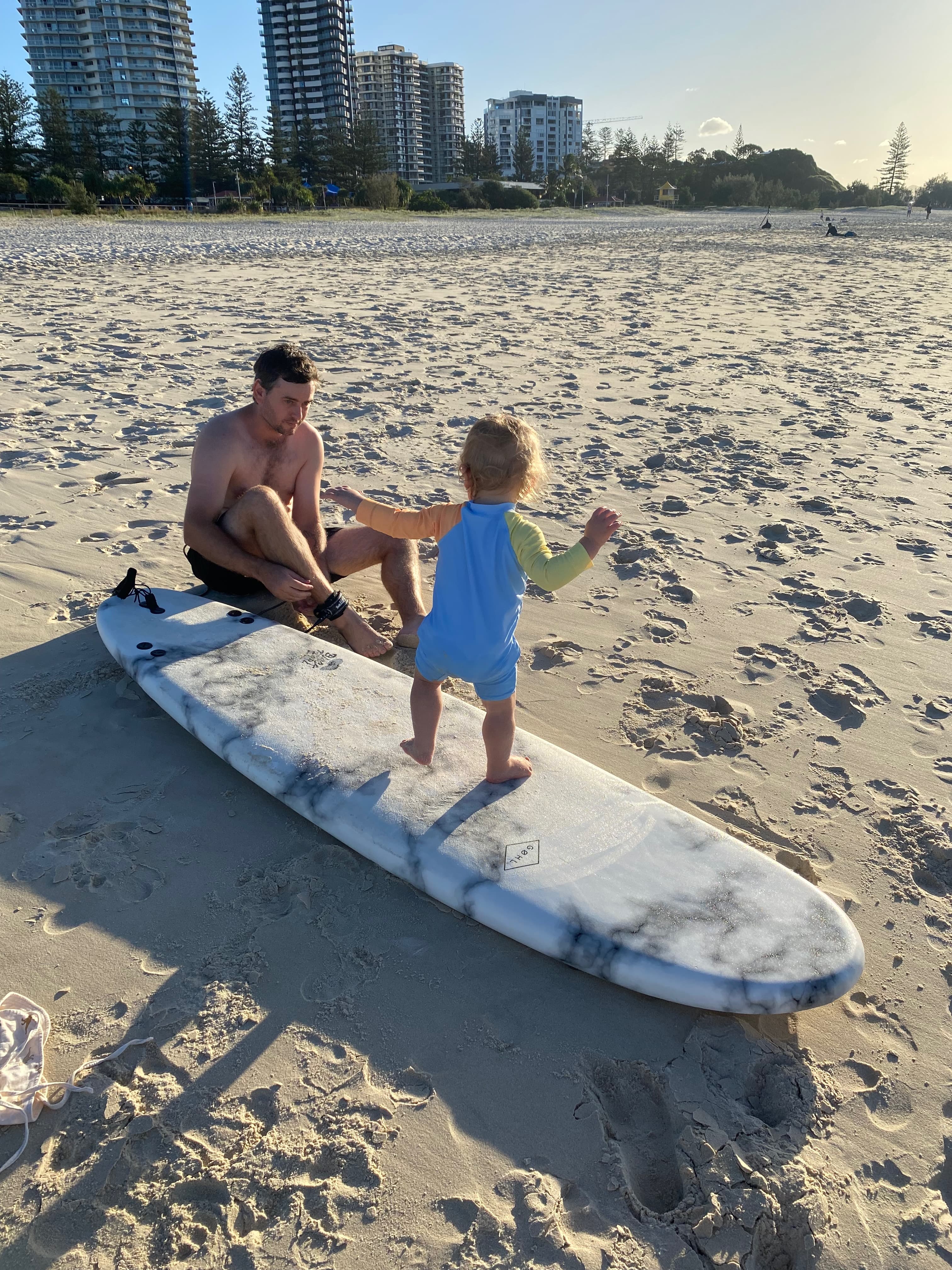 Regan and his son on a surfboard